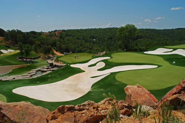 Detroit and all of Michigan lush green synthetic grass golf course with white sand bunkers and blue sky